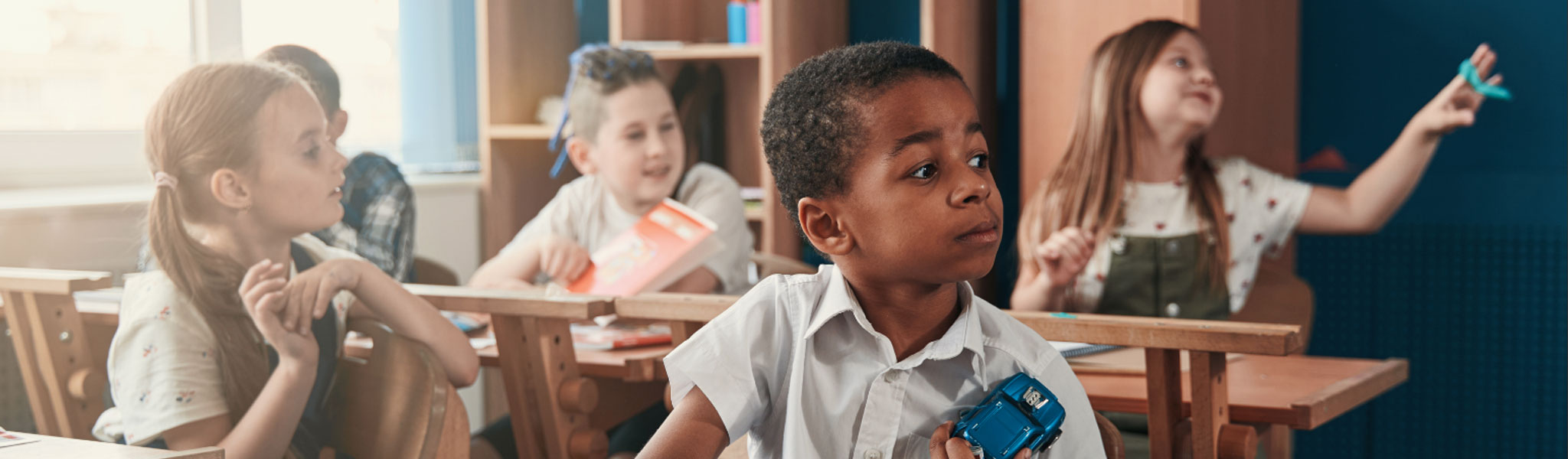 An image of school children sitting in the classroom