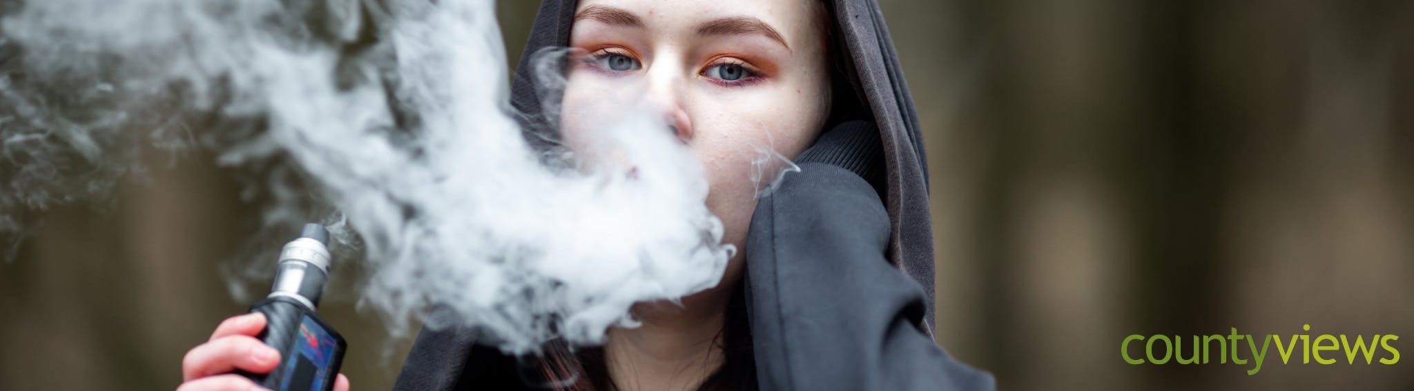 Young woman using an e-cigarette.