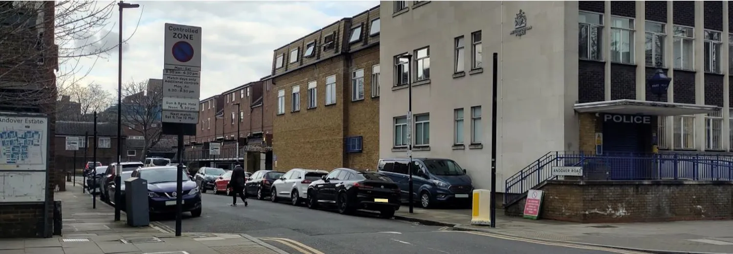Photo of parked vehicles and trees at the junction of Northolme Road and Highbury Park