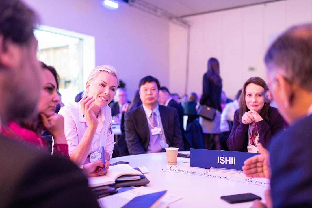 Male and female managers sitting around a table having a discussion